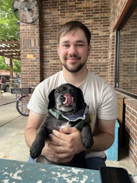 a man holding a dog